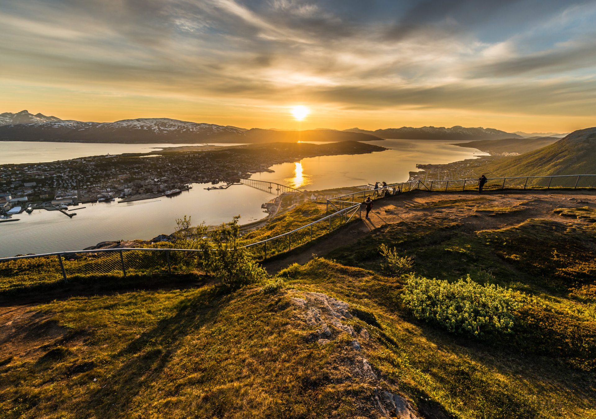 Tromso city in Tromsoya Island as seen from Mount Storsteinen under the Midnight Sun in Norway.